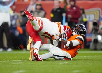 Nov 16, 2025; Denver, Colorado, USA; Denver Broncos cornerback Ja'Quan McMillian (29) sacks Kansas City Chiefs quarterback Patrick Mahomes (15) in the fourth quarter at Empower Field at Mile High. Mandatory Credit: Ron Chenoy-Imagn Images